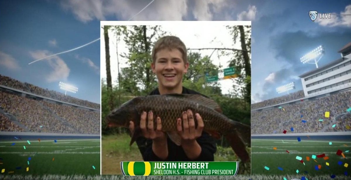 Rectangular image. Football stadium in the background, and a photo of a young Justin Herbert holding a large fish in the center. Text on the bottom center reads: JUSTIN HERBERT - SHELDON H.S. FISHING CLUB PRESIDENT