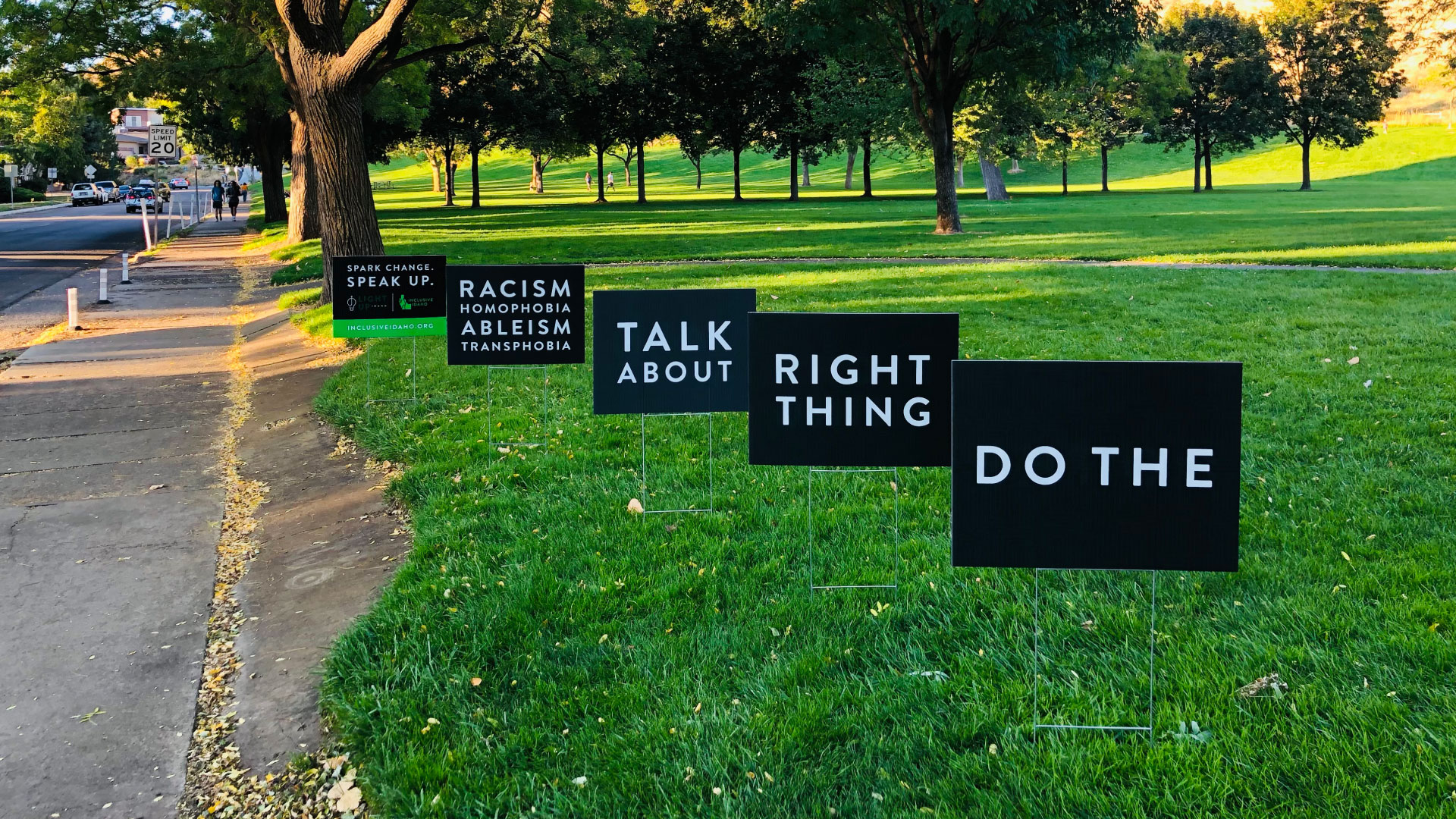 yard signs that read "do the right thing. spark change. speak up."