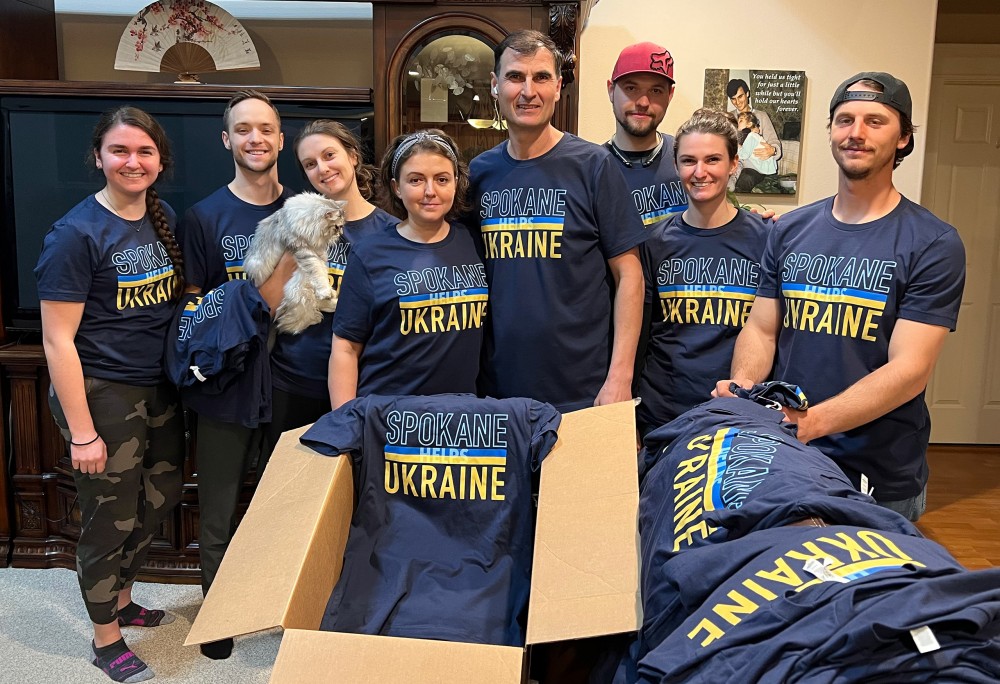 Family gathered wearing "Spokane helps Ukraine" shirts